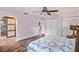 Bedroom featuring wood-look floors, and arched doorway leading to bathroom at 1625 Itchepackesassa Dr, Lakeland, FL 33810
