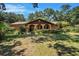 Charming single-story home with arched entryway, landscaped yard, and mature trees at 1625 Itchepackesassa Dr, Lakeland, FL 33810