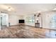 Bright living room featuring wood-look tile floors, ample natural light, and convenient access to the bathroom at 1625 Itchepackesassa Dr, Lakeland, FL 33810