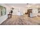 Spacious living room showcasing wood-look tile floors, seamlessly connecting to the kitchen and dining area at 1625 Itchepackesassa Dr, Lakeland, FL 33810