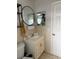 Bathroom with a sink vanity, round mirror, and tiled walls at 606 Lakespur Ln, Altamonte Springs, FL 32714