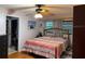 Comfortable bedroom featuring a ceiling fan, colorful quilt, and closet access at 606 Lakespur Ln, Altamonte Springs, FL 32714
