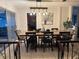 Open dining room with a large dining table, modern light fixture, and artwork at 606 Lakespur Ln, Altamonte Springs, FL 32714
