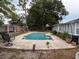 Backyard pool with a concrete surround, lush trees, and fencing at 606 Lakespur Ln, Altamonte Springs, FL 32714