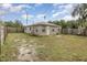 Backyard with a small, grassy area and a wooden fence at 130 E Pendleton Ave, Eustis, FL 32726