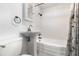 Bathroom with white tile, pedestal sink, and shower-tub combo at 130 E Pendleton Ave, Eustis, FL 32726