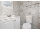 Stylish bathroom with a modern vanity, sink, and white-marble-patterned wall tiles at 130 E Pendleton Ave, Eustis, FL 32726