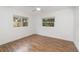 Inviting bedroom with wood-look floors, large windows, and ample natural light at 130 E Pendleton Ave, Eustis, FL 32726