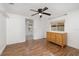 Inviting bedroom with wood-look floors, ceiling fan, and a window with a pleasant view at 130 E Pendleton Ave, Eustis, FL 32726
