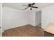 Bright bedroom featuring wood floors and ceiling fan at 130 E Pendleton Ave, Eustis, FL 32726