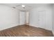 Spacious bedroom featuring wood-look floors, ceiling fan, and closet for ample storage at 130 E Pendleton Ave, Eustis, FL 32726