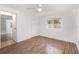 Comfortable bedroom with wood-look flooring, ceiling fan, and a view to the next room at 130 E Pendleton Ave, Eustis, FL 32726