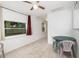 Bright dining area featuring neutral tile flooring, a window with a view, and a practical seating arrangement at 130 E Pendleton Ave, Eustis, FL 32726