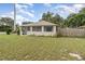 Exterior view of the home featuring a well maintained lawn at 130 E Pendleton Ave, Eustis, FL 32726