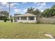 Exterior view of the home featuring a well maintained lawn at 130 E Pendleton Ave, Eustis, FL 32726