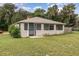 Charming house with screened porch and well-maintained front lawn at 130 E Pendleton Ave, Eustis, FL 32726