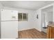 Bright kitchen with wood-look floors, modern refrigerator, and a window view to the yard at 130 E Pendleton Ave, Eustis, FL 32726