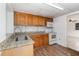 Well-equipped kitchen showcasing wood cabinets, laminate countertops, and modern appliances, creating a functional cooking space at 130 E Pendleton Ave, Eustis, FL 32726
