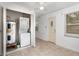 Convenient laundry area with stacked washer and dryer, water heater, and tiled floor at 130 E Pendleton Ave, Eustis, FL 32726