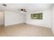 Sunlit living room features neutral tile, a ceiling fan, bright windows, and clean, white walls, offering a versatile layout at 130 E Pendleton Ave, Eustis, FL 32726