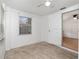 Cozy room featuring neutral tile flooring, a bright window, and access to another room at 130 E Pendleton Ave, Eustis, FL 32726