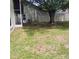 A spacious, well-maintained backyard with mature trees and privacy fencing at 1416 Silverthorn Dr, Orlando, FL 32825