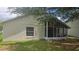 The house features a screened-in porch, a window, and lush greenery at 1416 Silverthorn Dr, Orlando, FL 32825