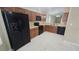 Well-equipped kitchen features black appliances, wood cabinets, and easy access to the living areas at 1416 Silverthorn Dr, Orlando, FL 32825