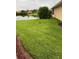 A lush green backyard with view of lake at 2202 Garden Lake Dr, Winter Haven, FL 33884