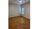 Bedroom featuring beautiful wood flooring, ceiling fan and a window with blinds at 2202 Garden Lake Dr, Winter Haven, FL 33884