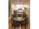 Cozy dining area with a modern chandelier and a view of the kitchen's breakfast bar at 2202 Garden Lake Dr, Winter Haven, FL 33884