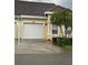 Charming home features a one-car garage and well-maintained landscaping with a palm tree at 2202 Garden Lake Dr, Winter Haven, FL 33884