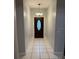 Inviting foyer with tile flooring and a decorative chandelier welcomes you home at 2202 Garden Lake Dr, Winter Haven, FL 33884