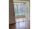 Sunroom with window blinds, view of yard and a white door with a silver door handle at 2202 Garden Lake Dr, Winter Haven, FL 33884