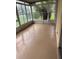 Enclosed sunroom featuring speckled flooring and sliding glass windows with view of backyard at 2202 Garden Lake Dr, Winter Haven, FL 33884