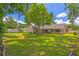 Spacious backyard with lush green grass, mature trees, and a privacy fence, creating a serene outdoor space at 2921 Se 38 Pl, Ocala, FL 34480