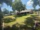 Expansive backyard with mature trees, providing shade and privacy, complemented by lush green grass at 2921 Se 38 Pl, Ocala, FL 34480