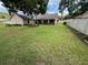 Large, well-maintained backyard with lush green grass, mature trees, and a privacy fence at 2921 Se 38 Pl, Ocala, FL 34480