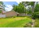 Lush backyard featuring green lawn, mature trees, and a white vinyl fence enclosing the property at 2921 Se 38 Pl, Ocala, FL 34480