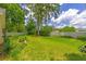 Expansive backyard with green lawn, mature trees, and white vinyl fence at 2921 Se 38 Pl, Ocala, FL 34480