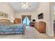 Spacious bedroom features natural light from glass doors, with a dresser and a flat screen television at 2921 Se 38 Pl, Ocala, FL 34480