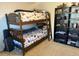 A bedroom with bunk beds and shelving to accommodate toys at 2921 Se 38 Pl, Ocala, FL 34480