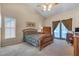 Bedroom with vaulted ceiling features a ceiling fan, window with blinds, and a glass door with curtains at 2921 Se 38 Pl, Ocala, FL 34480