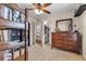 Bedroom featuring a bunk bed, dresser, closet, and doorway to another room at 2921 Se 38 Pl, Ocala, FL 34480
