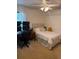 Bedroom featuring a desk with triple monitors, a cozy bed, and soft natural light at 2921 Se 38 Pl, Ocala, FL 34480