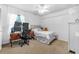 Bright bedroom features a desk, multiple monitors and a comfortable bed for a relaxing space at 2921 Se 38 Pl, Ocala, FL 34480