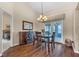 Bright dining area with wood floors, chandelier, and sliding doors to the outdoor area at 2921 Se 38 Pl, Ocala, FL 34480