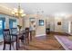 View of the dining room featuring wood floors and a chandelier hanging over the dining table with seating for four at 2921 Se 38 Pl, Ocala, FL 34480