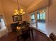 Dining area featuring wood floors, a chandelier, and access to an enclosed sunroom at 2921 Se 38 Pl, Ocala, FL 34480