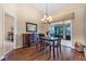 Dining area featuring a chandelier, wooden table and chairs, cabinet and patio access at 2921 Se 38 Pl, Ocala, FL 34480
